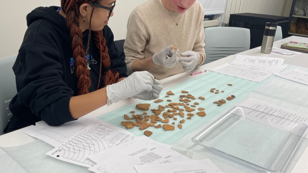 Examining shards of ceramic in the HA Lab 