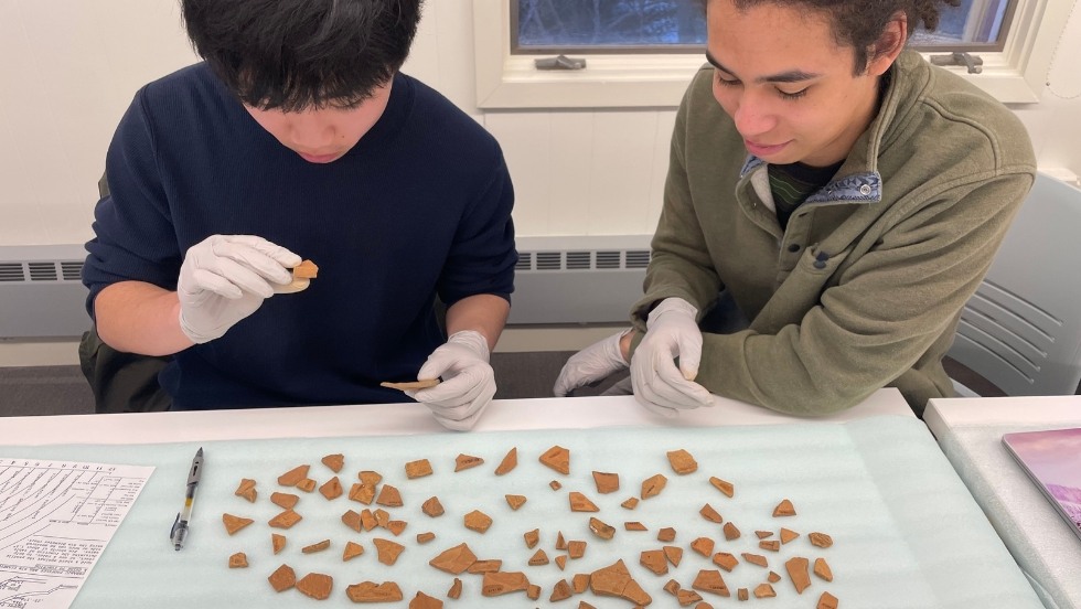 Examining shards of ceramic in the HA Lab 